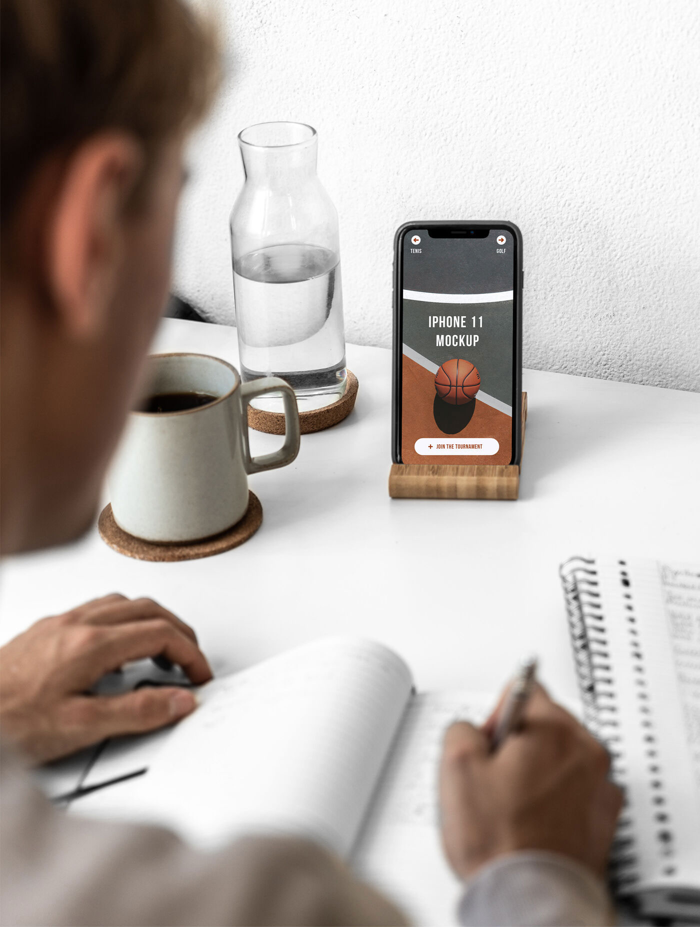 iPhone 11 on a Desk Featuring a Man Mockup preview