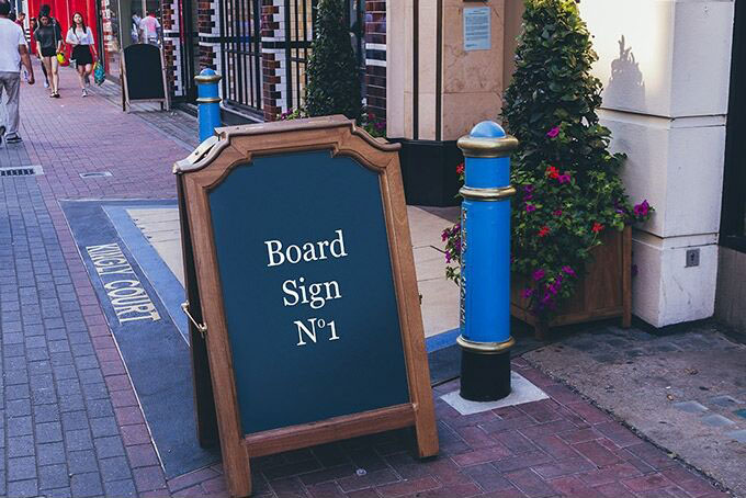 Mockup of a Stylish and Wooden Board Sign on the Street