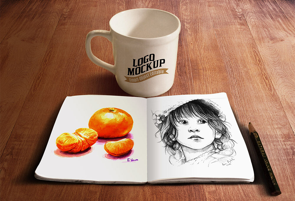 Mockup Featuring a Simple Mug and a Sketchbook