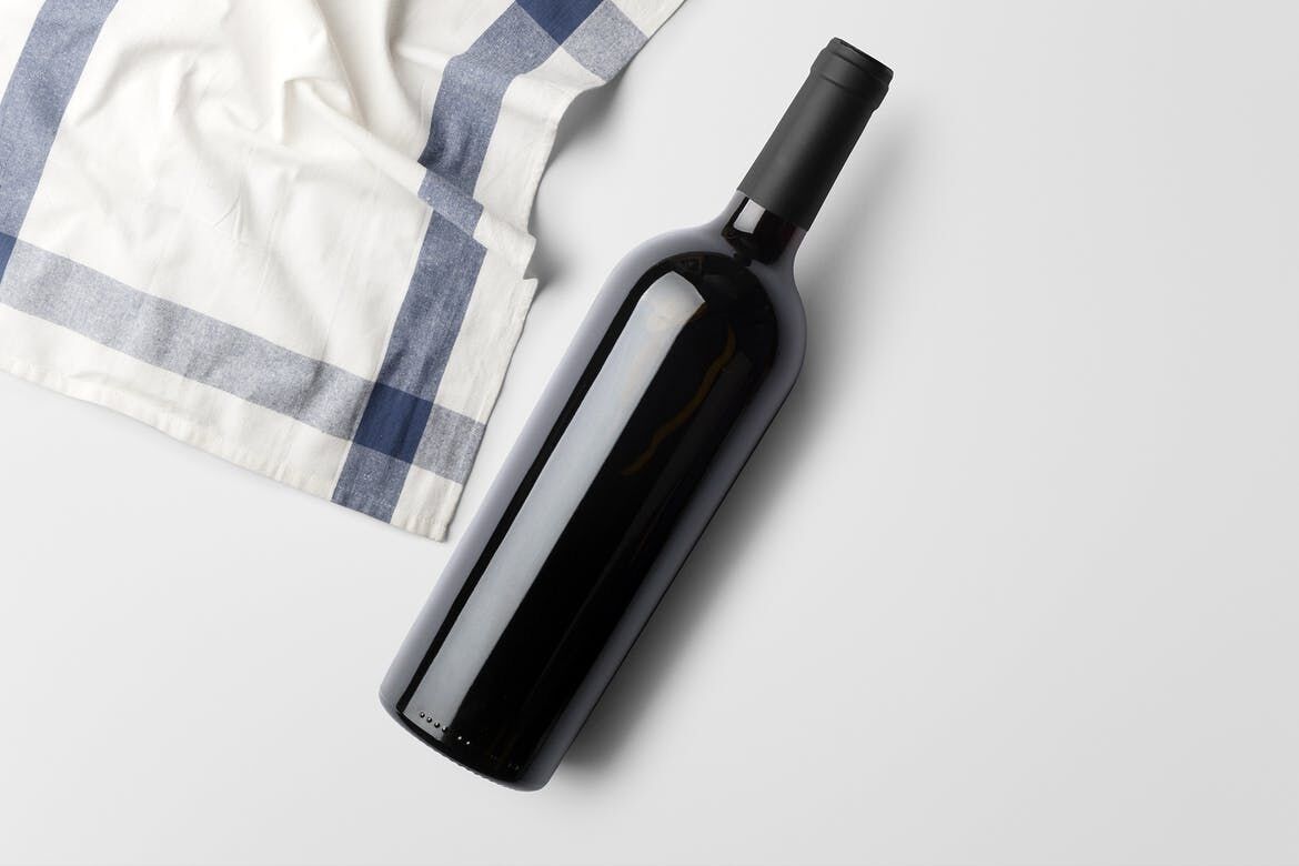 Mockup Showing Standing and Lying on the Ground Wine Bottle Surrounded with Edible Items