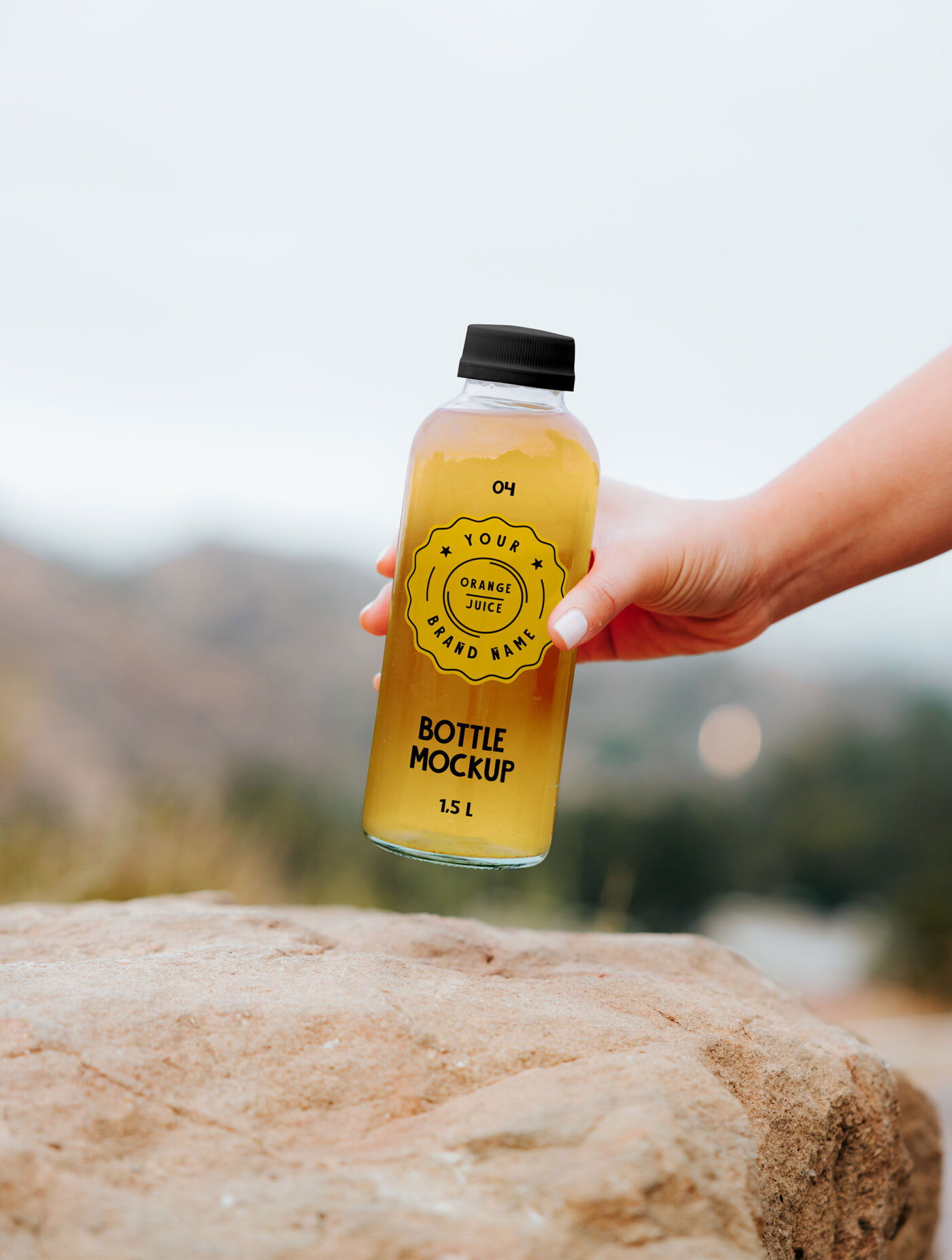 Mockup of a Transparent Bottle Held by Hand preview