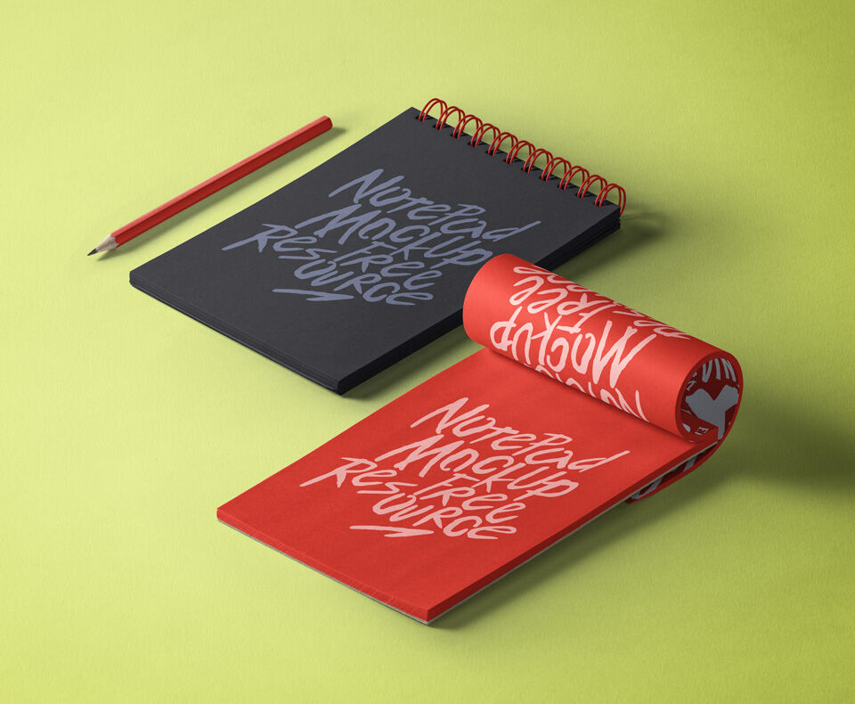 Mockup Showcasing Wired and Partly Rolled Notepad and a Floating Pen
