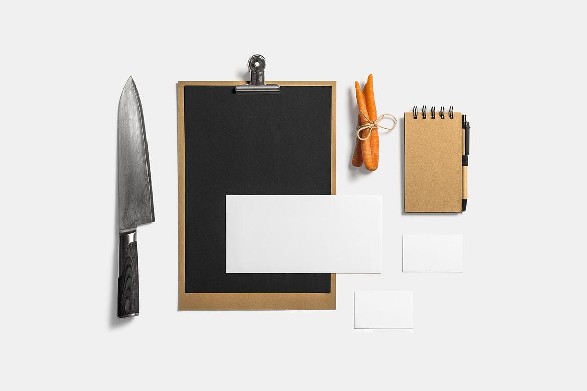 Mockup Showcasing Menu, Business Cards, Notebook Beside Knife and Carrots