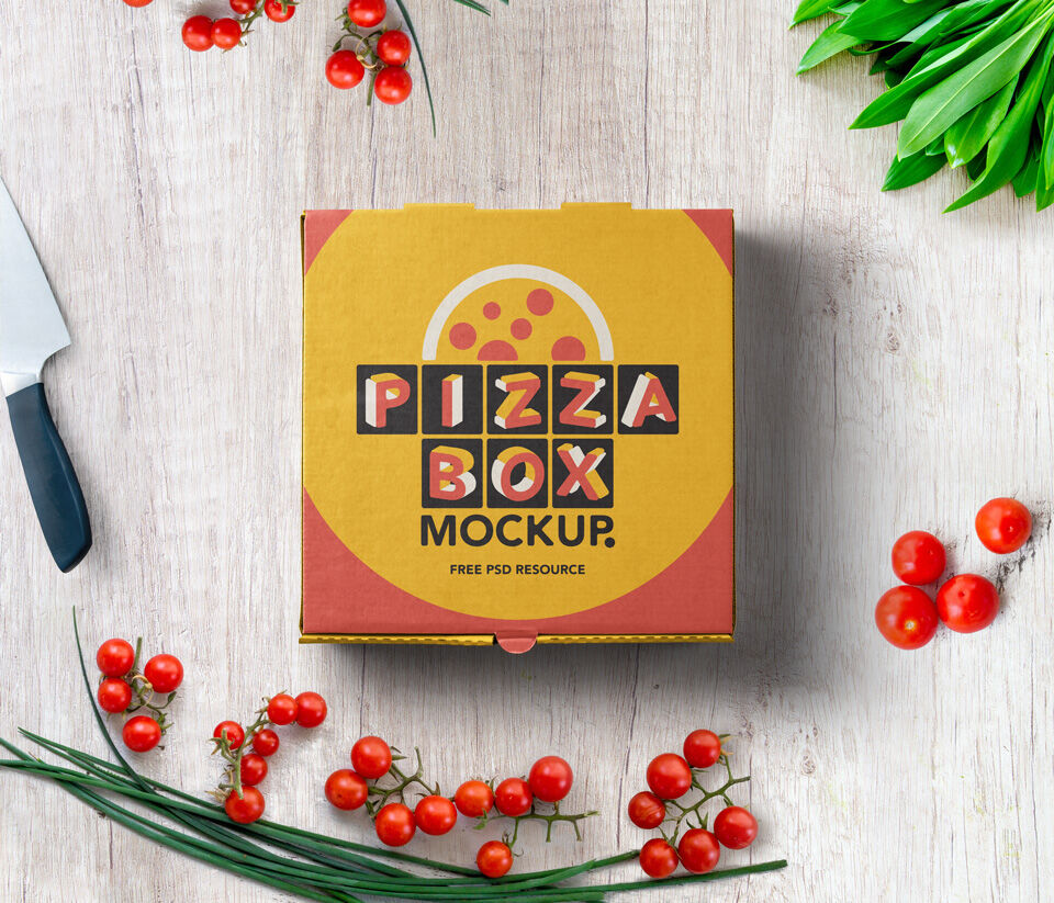 Mockup Displaying Top View of a Pizza Box on Wooden Surface Beside Cherry Tomatoes