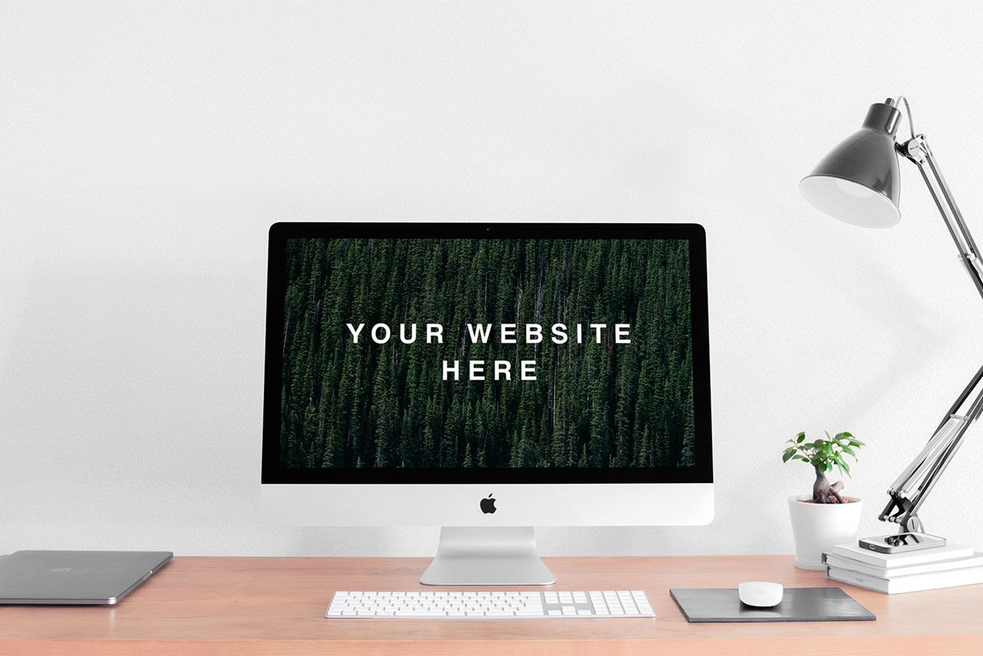 Mockup Featuring Realistic iMac on a Desk Next to a Lamp and a Plant