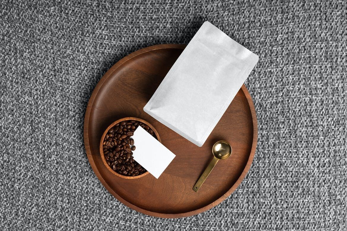Mockup Featuring Wooden Round Tray Filled with Bowl of Coffee Beans, Paper Bag and Business Card