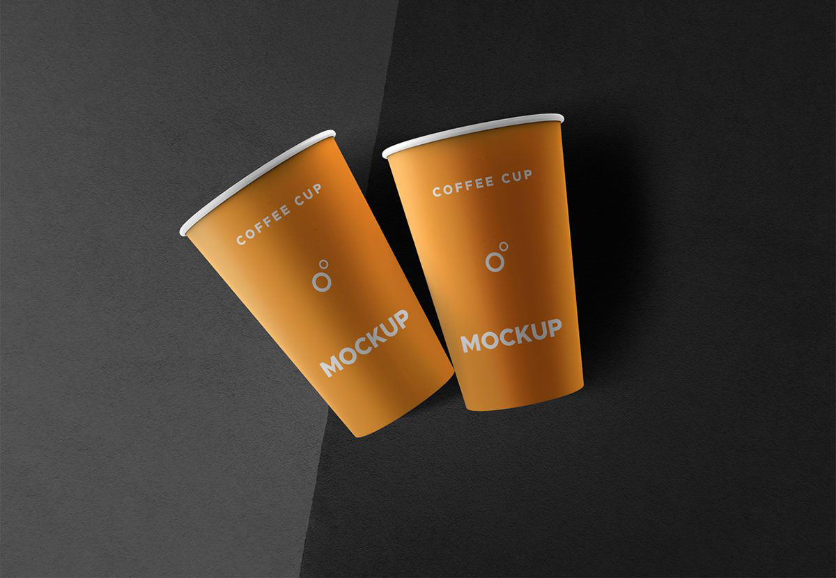 Two Coffee Cups Lying on a Flat Surface Mockup