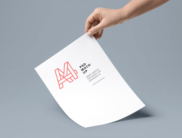 A4 Paper in a Hand Mockup