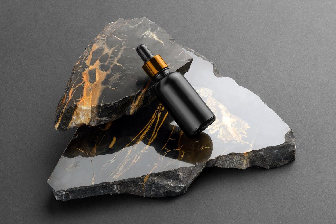 Bottle with Dripper Cosmetics Mockup on a Marble Stones