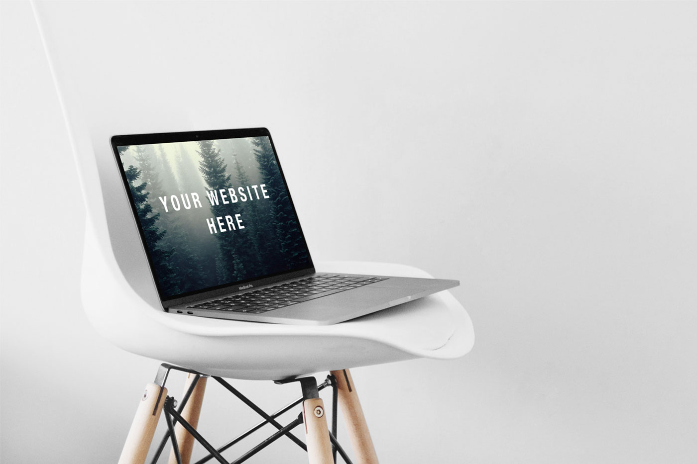 Open MacBook Pro on a Chair Mockup