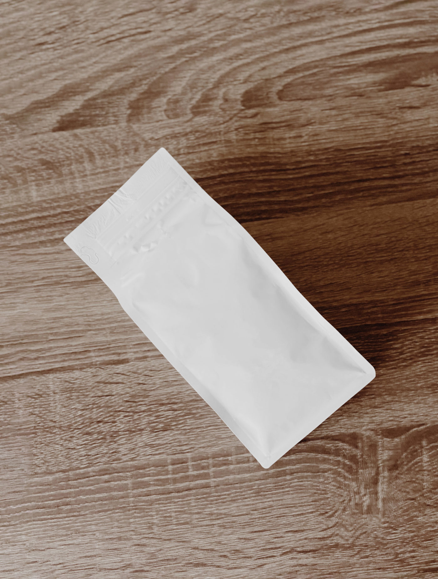 Top View of Coffee Bag Mockup on Wooden Table