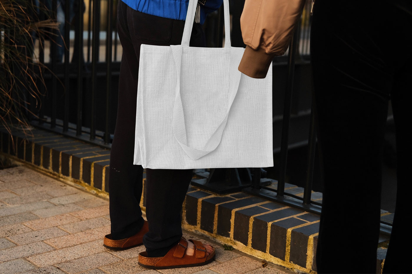 Hand Holding the Realistic Medium Canvas Bag Mockup preview