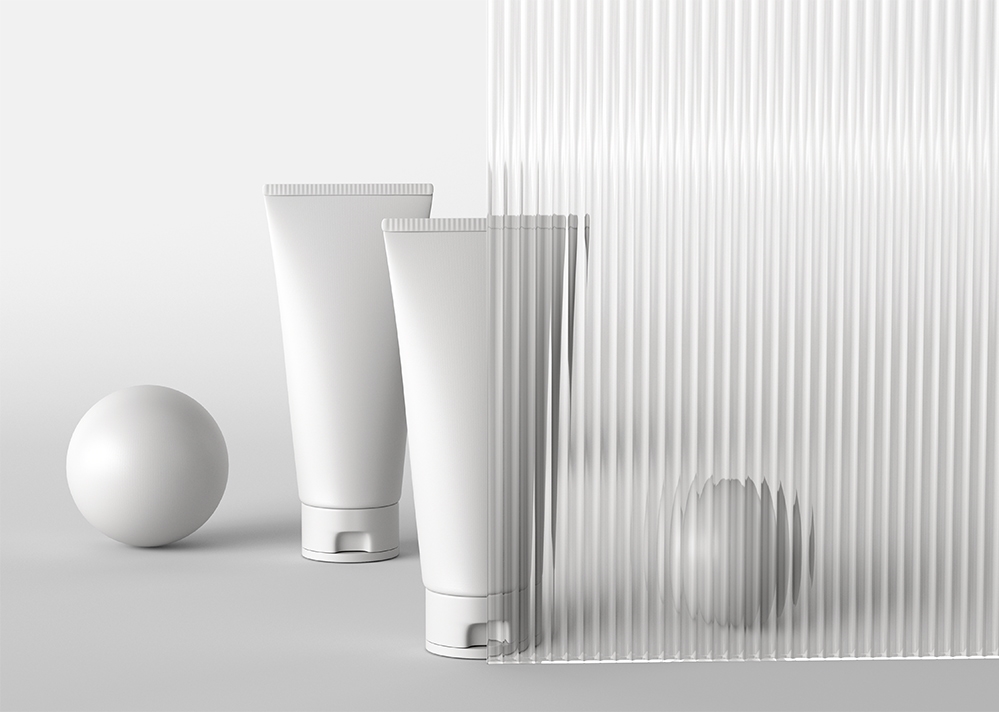 Cosmetic Packaging Mockup Featuring Two Tubes against a Glass Wall