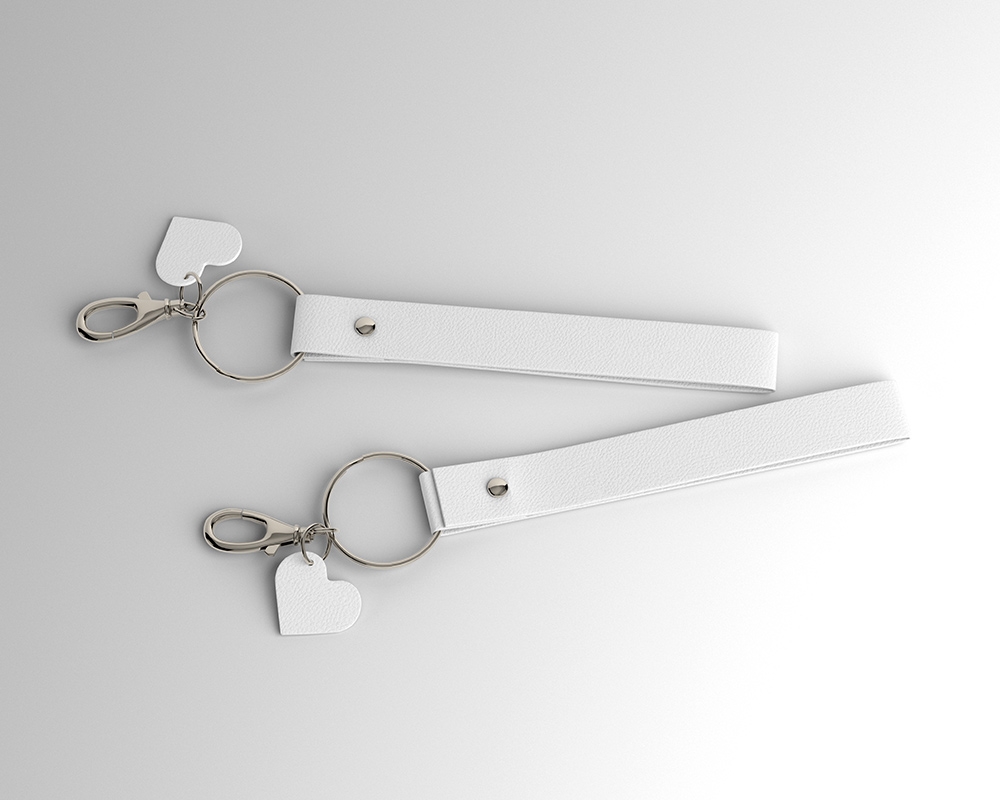 2 Leather Keyrings Laid on the Surface in Top View Mockup