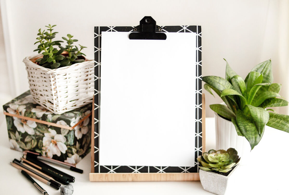 Clipboard with Paper in Wooden Stand Mockup Featuring Plant Pots preview