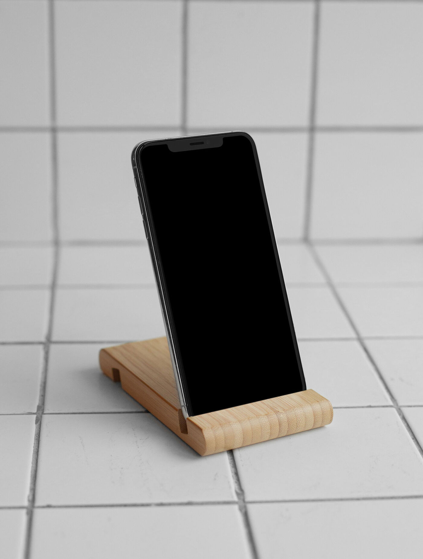 iPhone on Wooden Stand Mockup with Tiled Floor and Wall preview