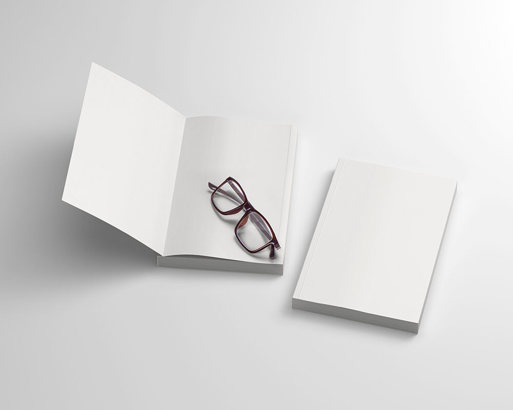 Mockup Featuring Two Open and Closed Softcover Books with Glasses preview