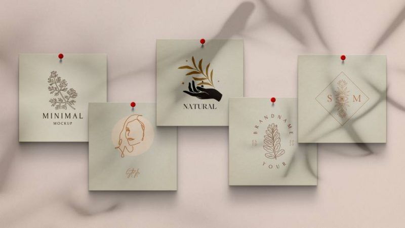 Overhead View of Five Square Papers Pinned to Wall Mockup