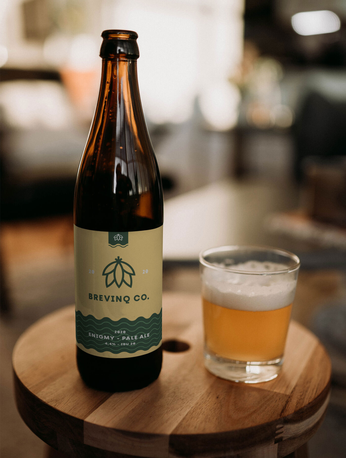 Realistic Mockup of a Beer Bottle on a Round Wooden Table